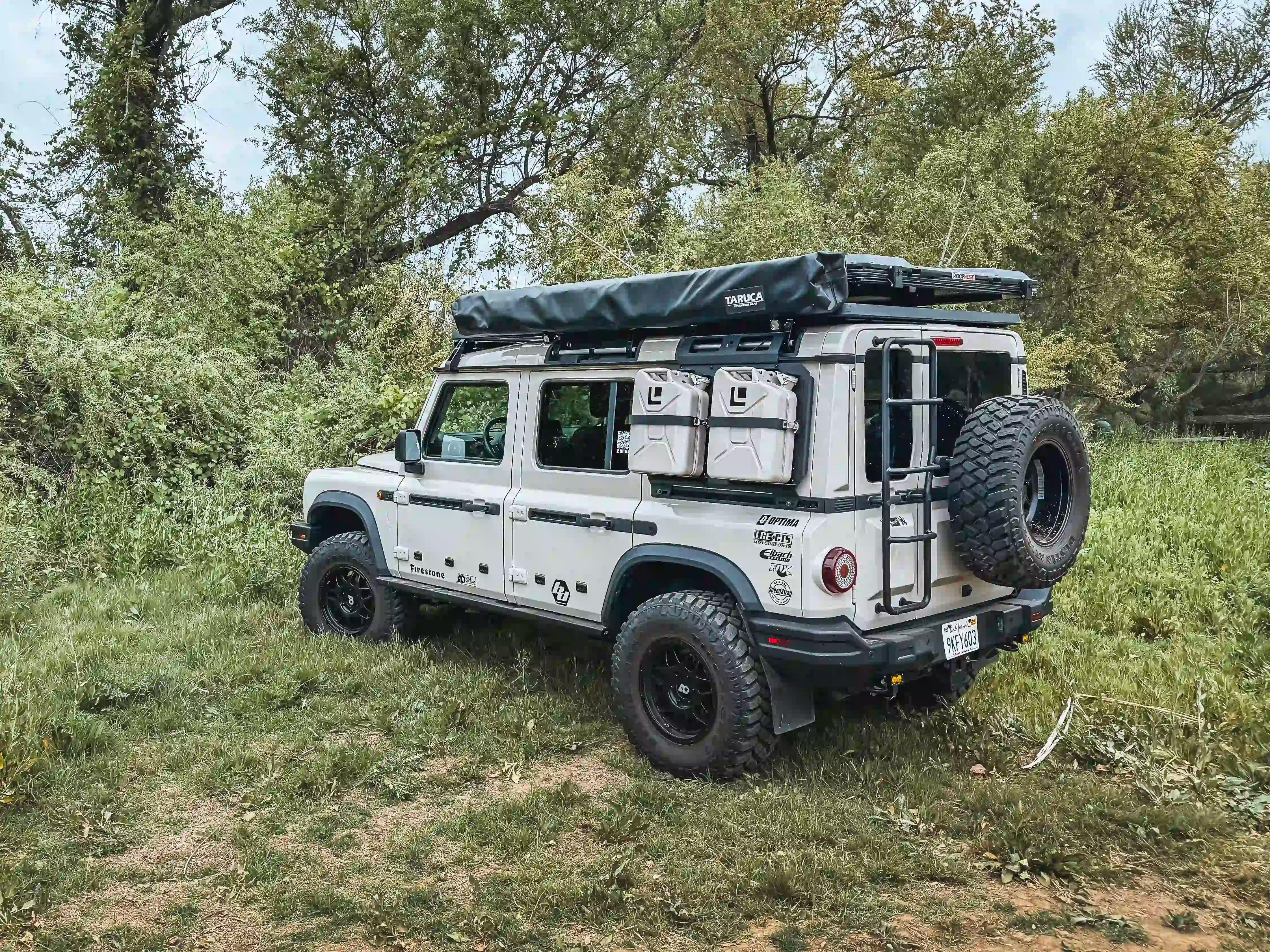 INEOS GRENADIER OUTSIDE WITH ROOF TOP TENT ATTACHED TO LOAD BAR INSTALLED ON ACS ROOF RACK