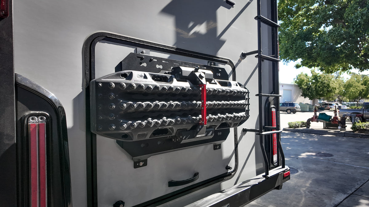 Recovery boards mounted on a MOLLE panel on a van door