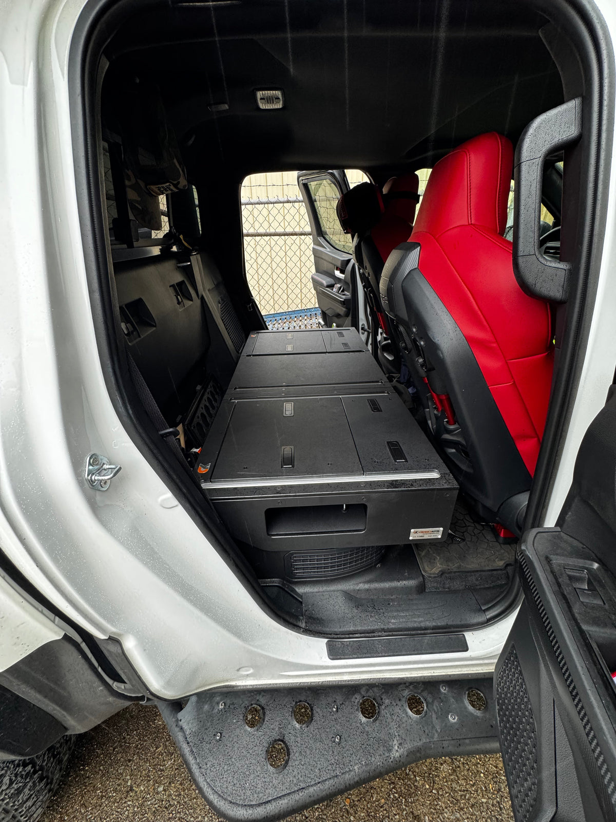 CargoKits Rear Seat Delete installed in a Tacoma TRD Pro Hybrid with red leather seats, real install photo