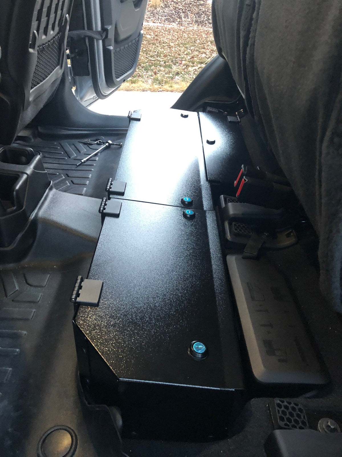 Lock box installed under a Gladiator rear seat with all lids closed