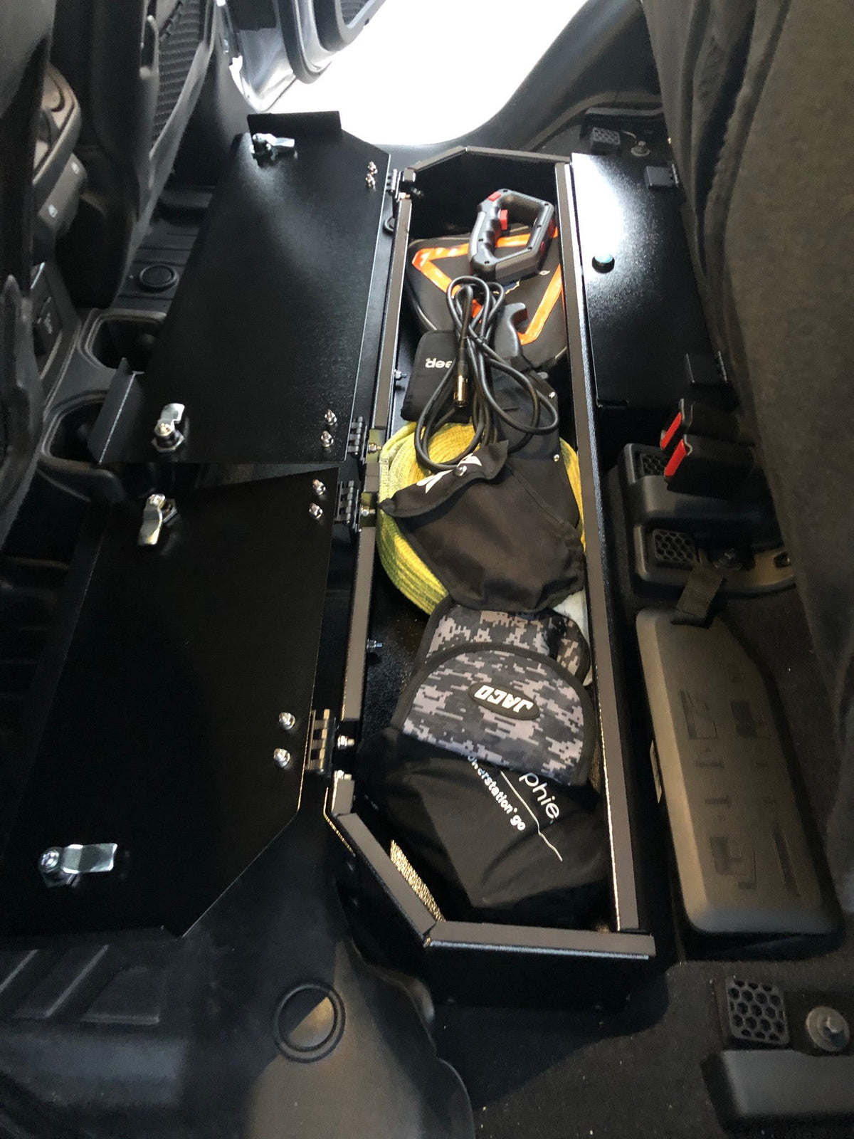 Gladiator lock box open with recovery gear and bags inside