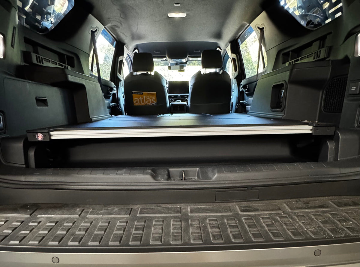 CargoKits Base Plate System in a 4Runner Hybrid, low angle view through the tailgate opening from outside the vehicle