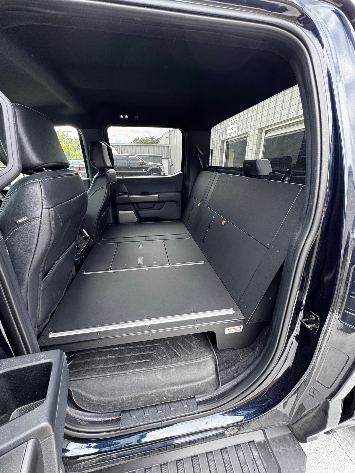 CargoKits Rear Seat Delete in a Ford F-Series SuperCrew, close-up of the platform's accessory rail and access hatch