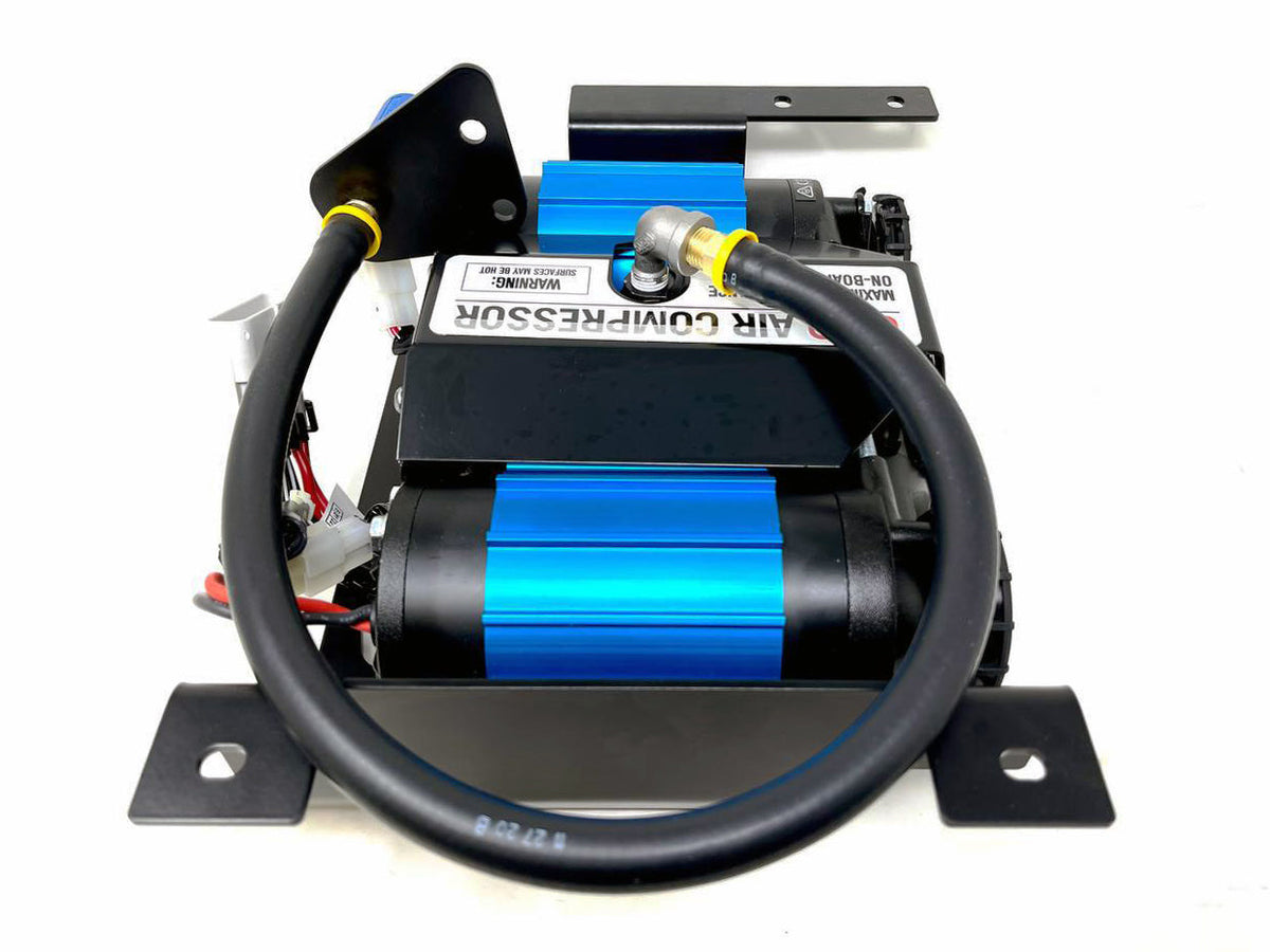 Twin blue air compressor on a black mount with a black hose