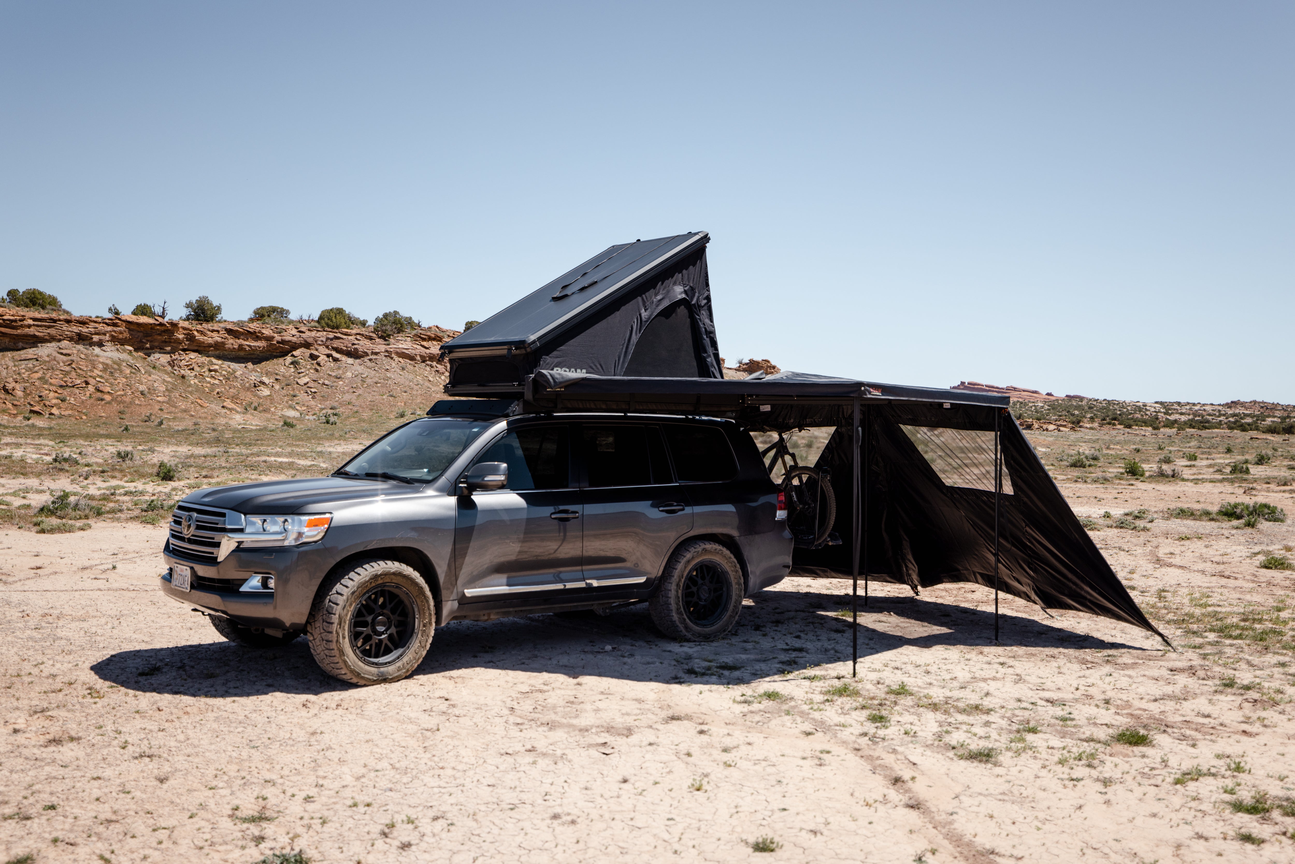 ROAM ARC 270 awning walls providing shade and privacy at camp