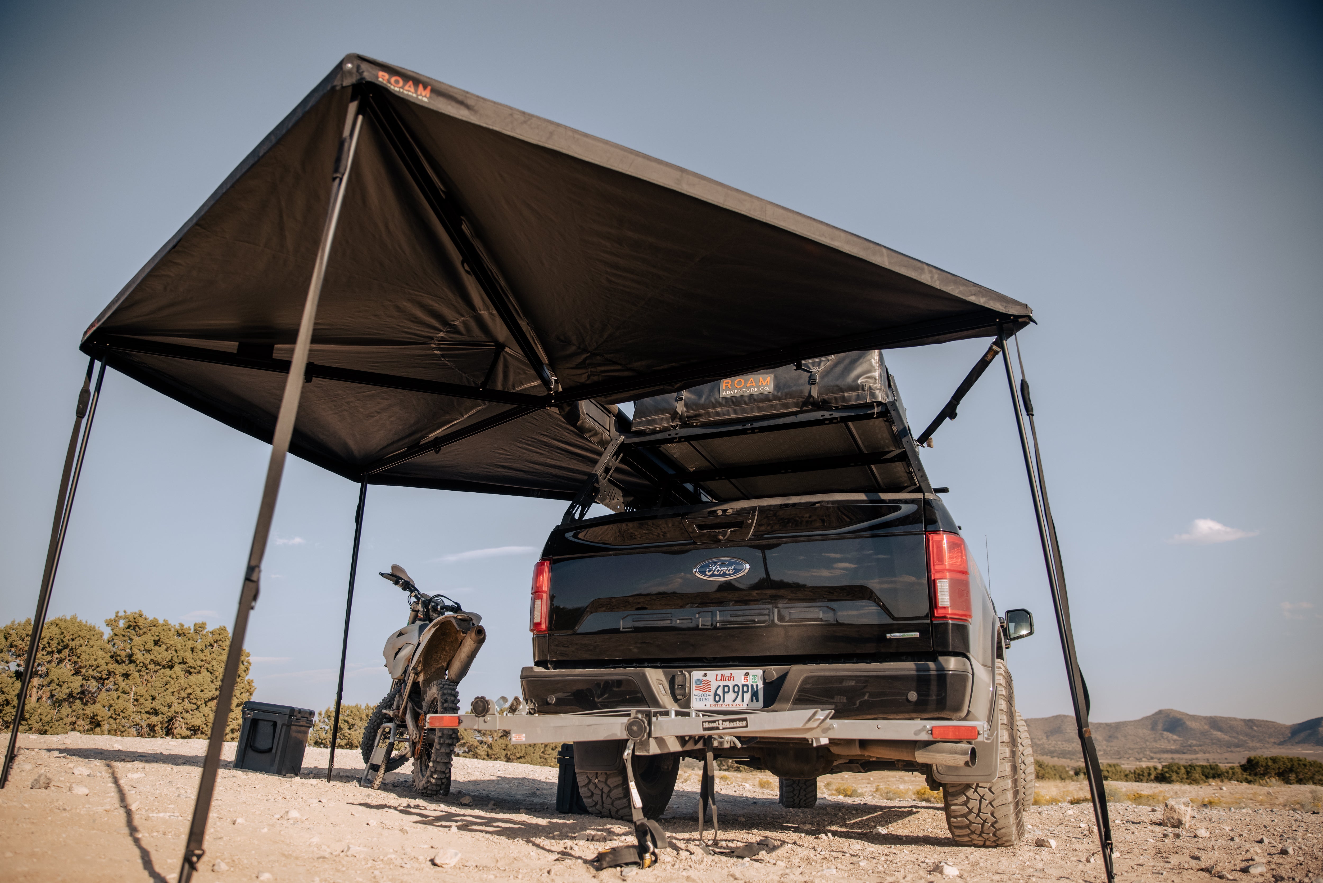 ROAM ARC 270 awning set up beside a vehicle