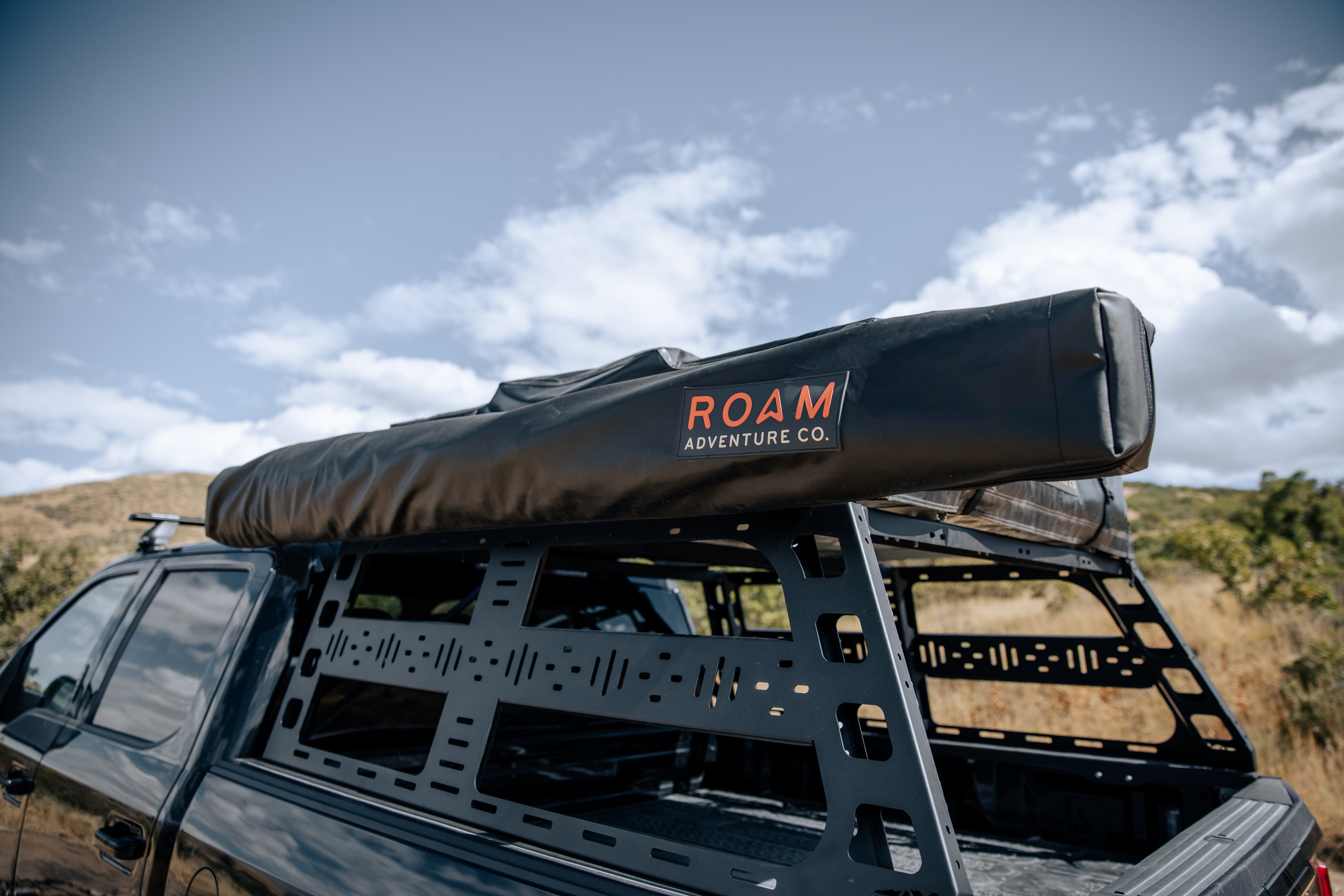 ROAM ARC 270 awning shading a camp table
