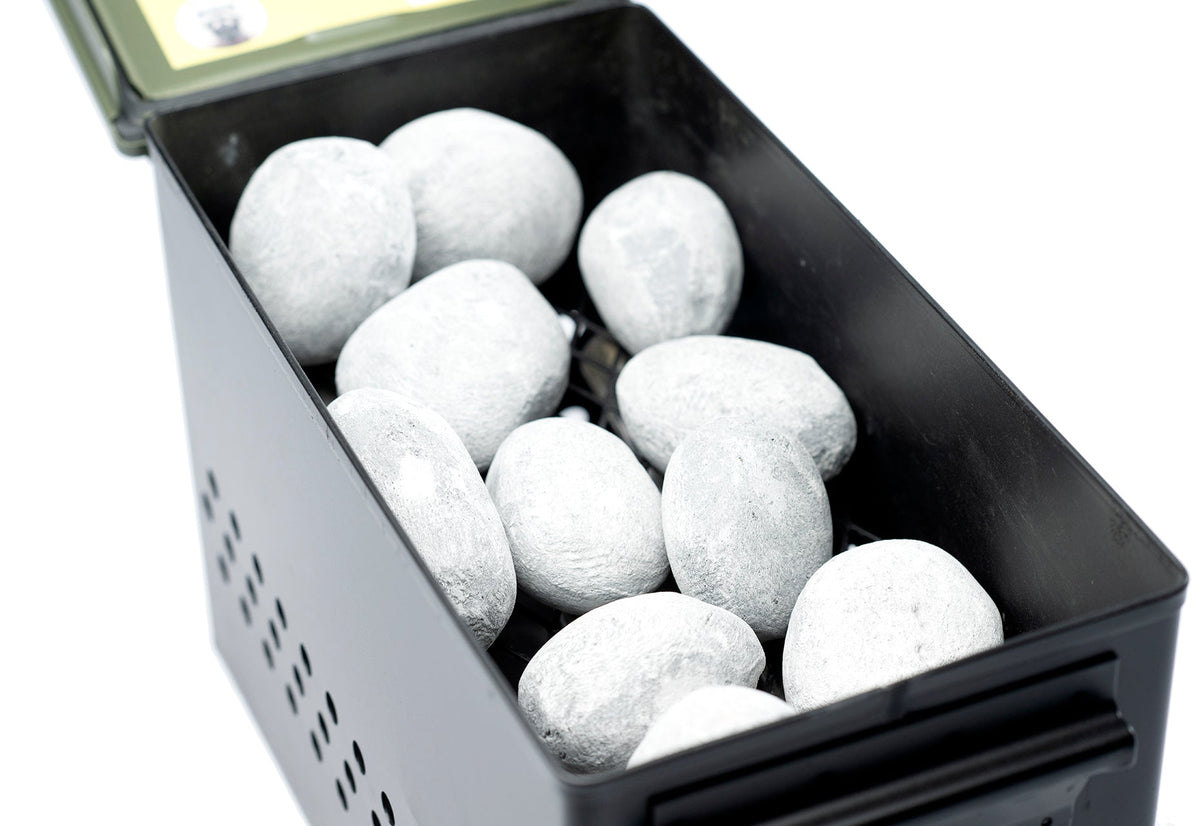 Overhead close-up of an olive green firebox filled with light gray Hades Stones