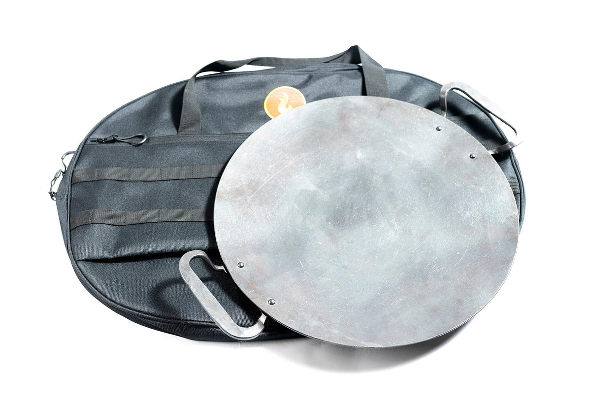 Round black steel griddle disc stored inside its black padded carry bag, studio shot