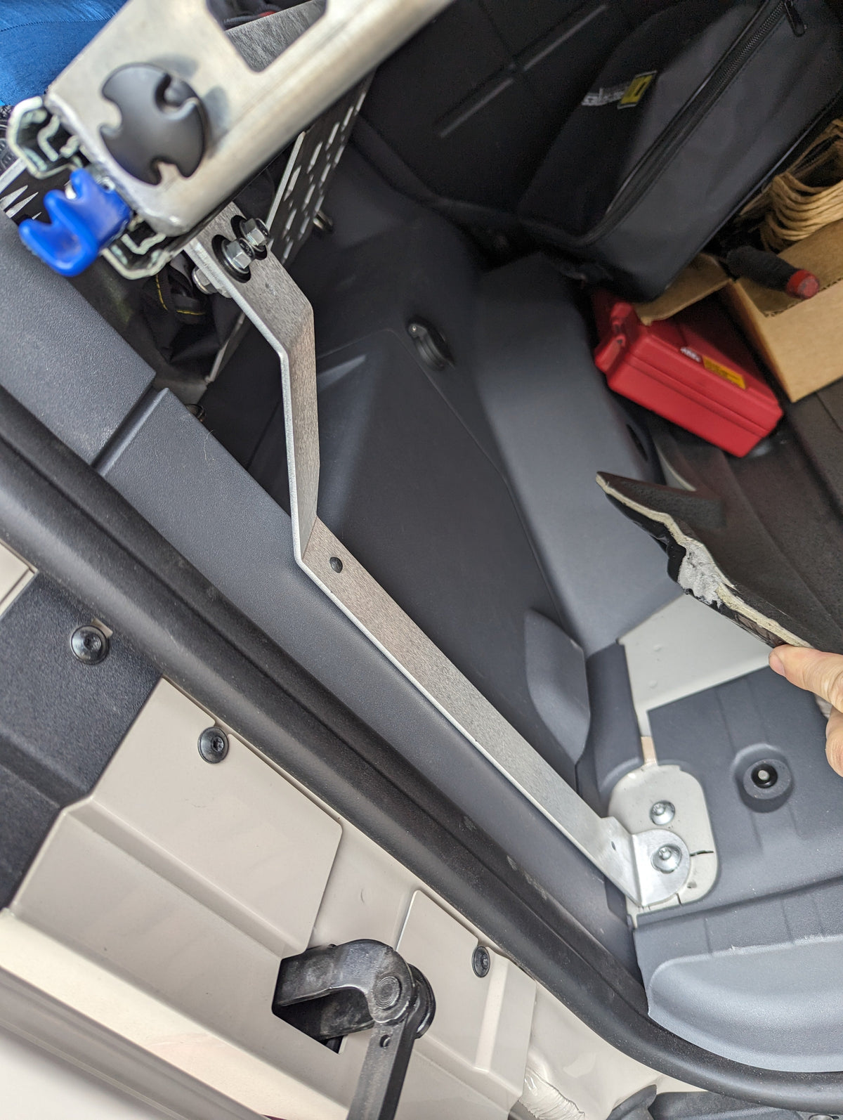 Close view of a shelf support and mounting point at the rear of the cargo area