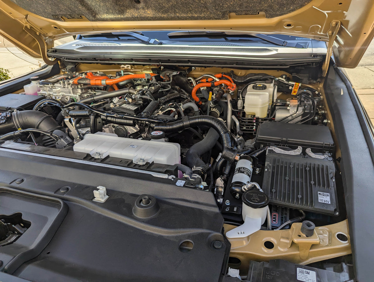 Raised hood showing the compressor installed in the engine bay