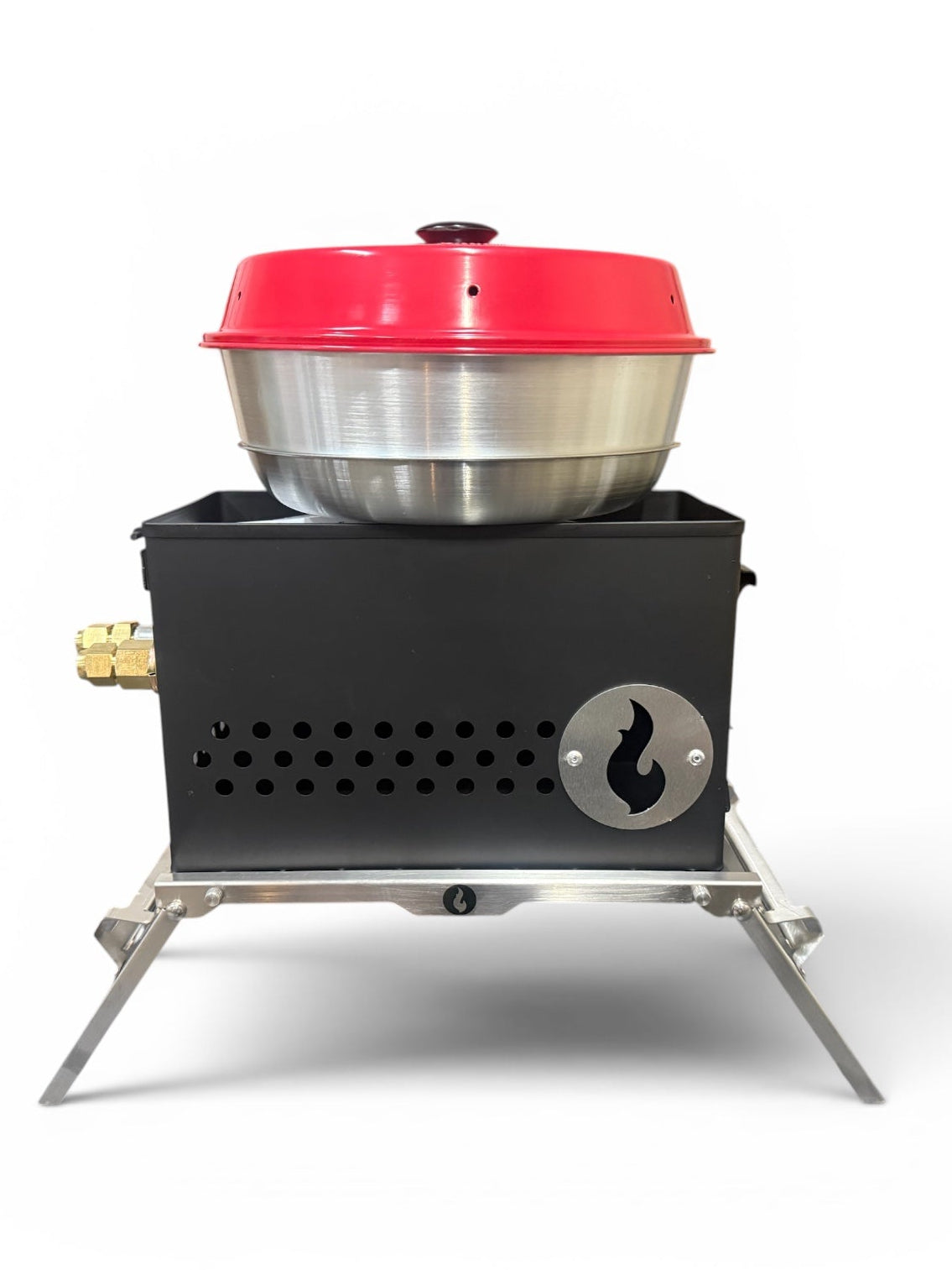 Black steel firebox topped with a stainless mixing bowl and red lid, folding legs extended, studio shot on white background