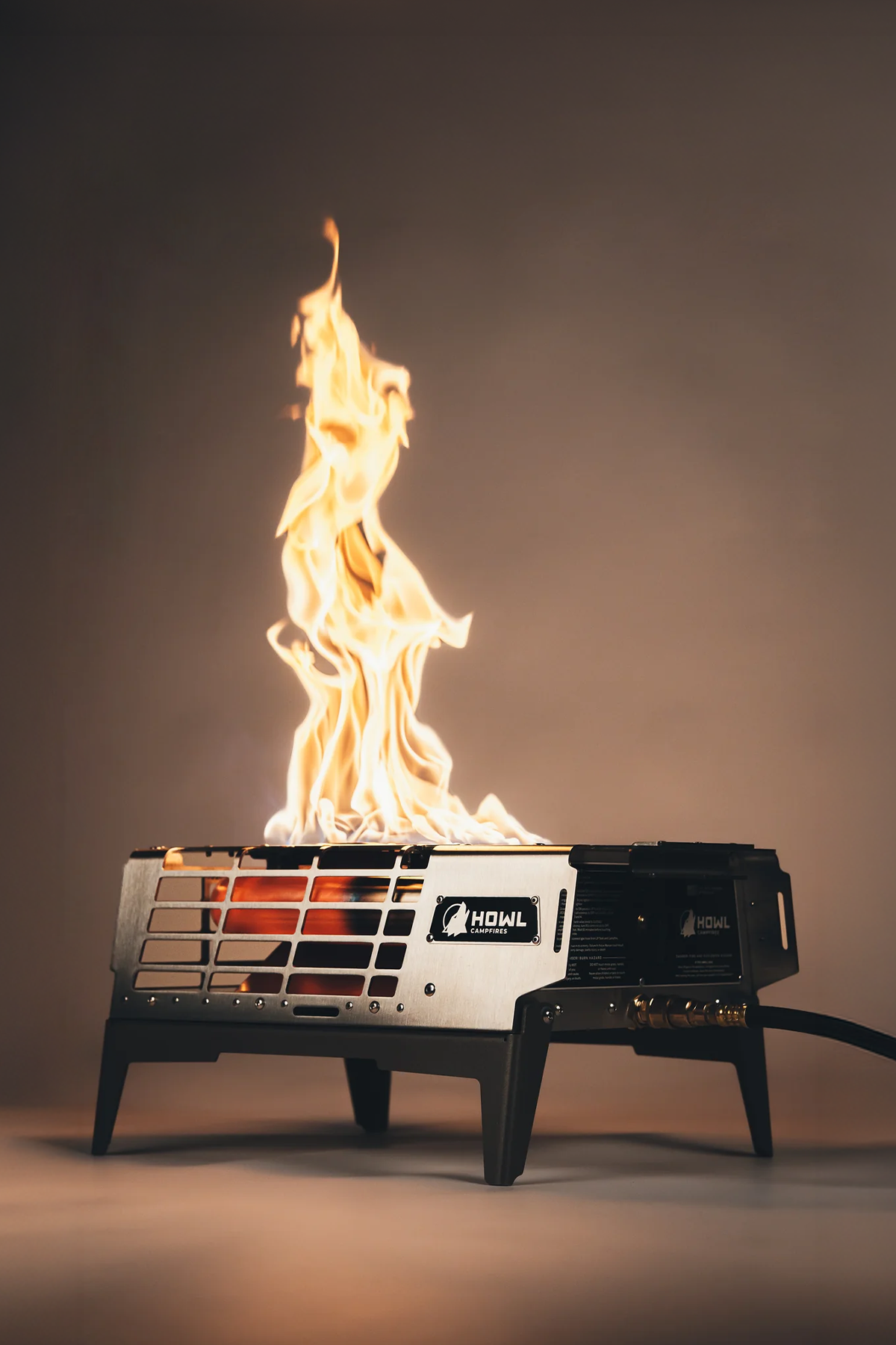 Howl R3 propane campfire burning at night, flame rising above the BarCoal tube and A-Flame burner