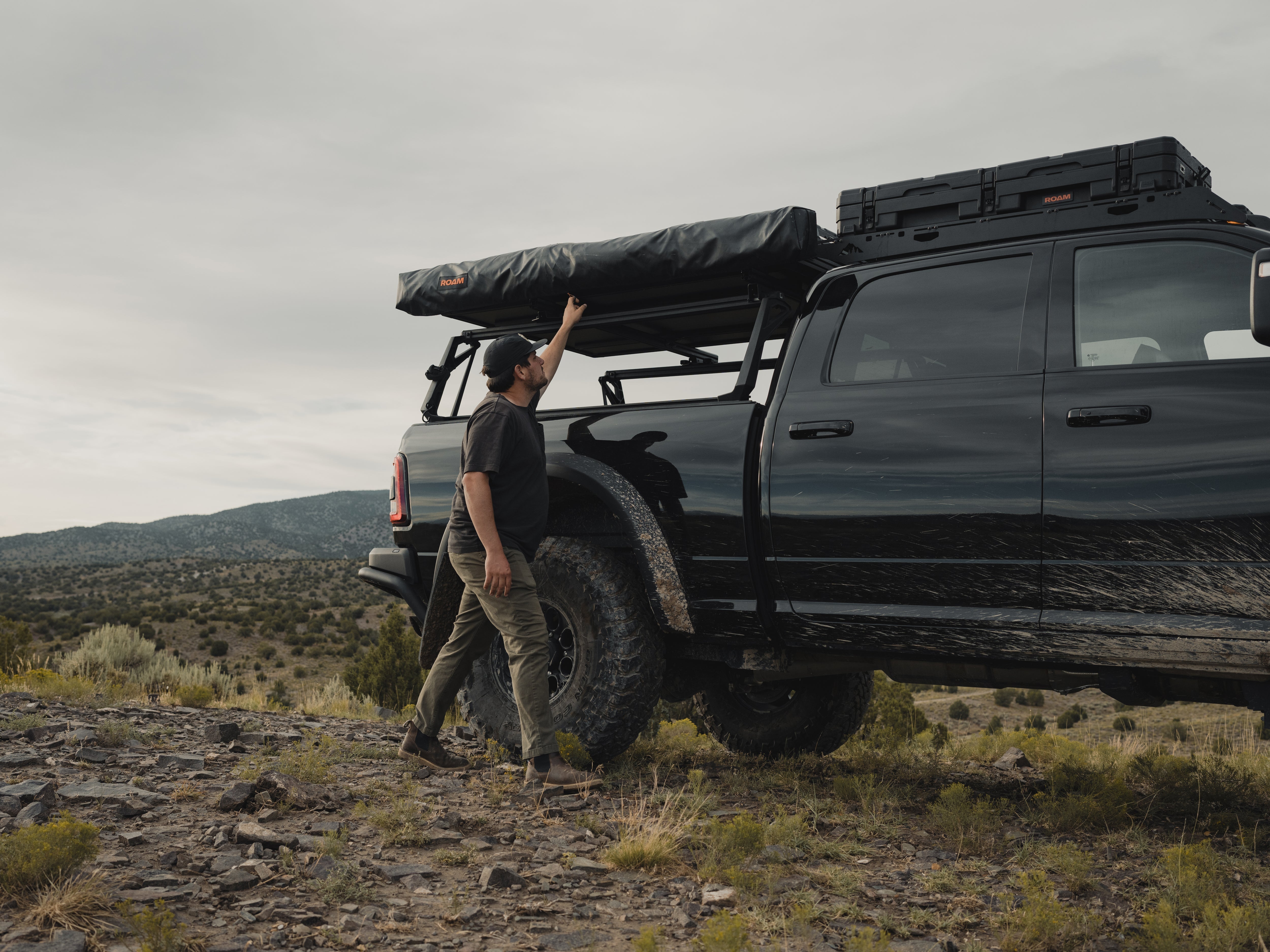 Vehicle with a ROAM ARC 180 awning at an overland camp