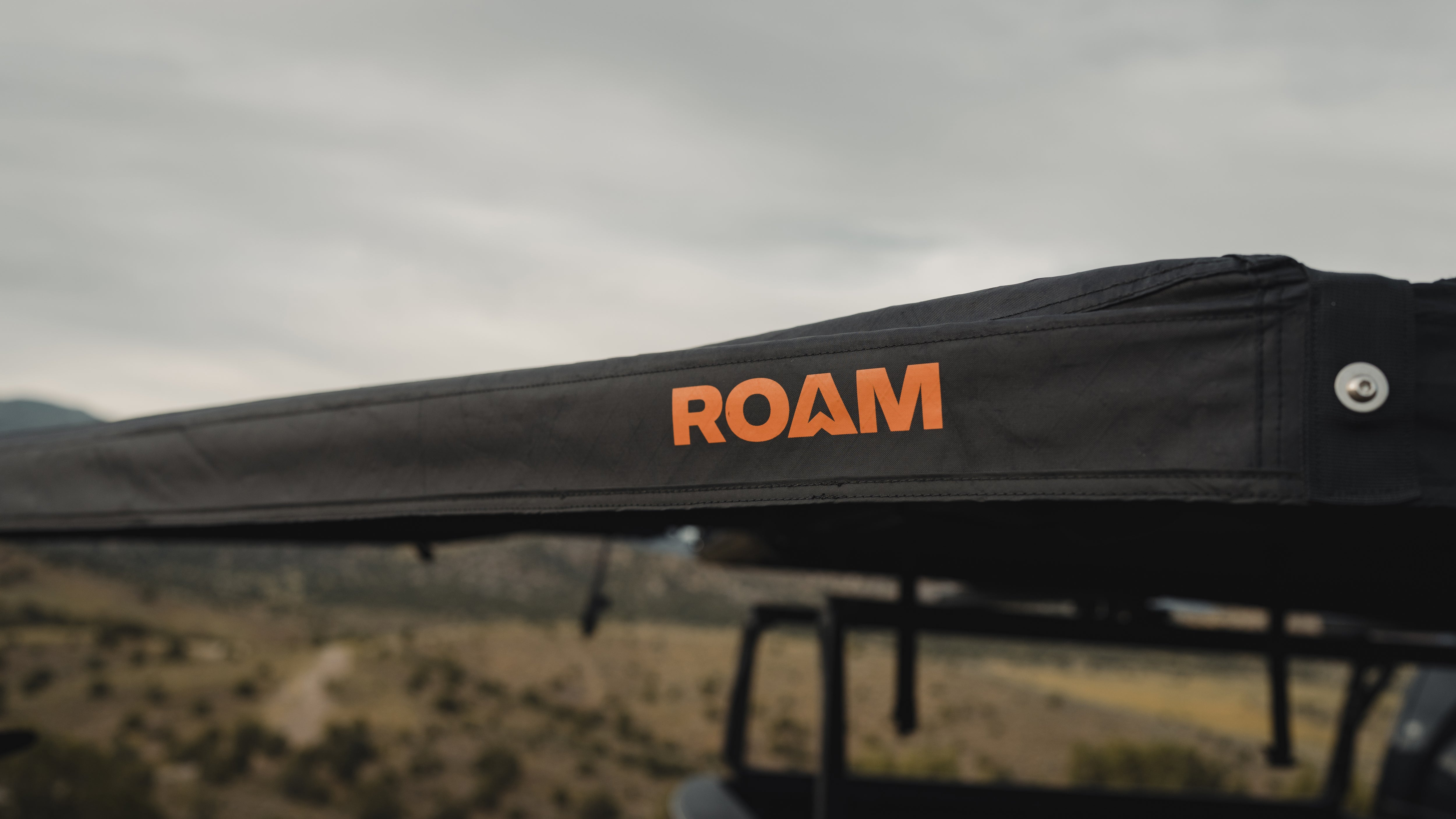 ROAM ARC 180 awning extended over a campsite