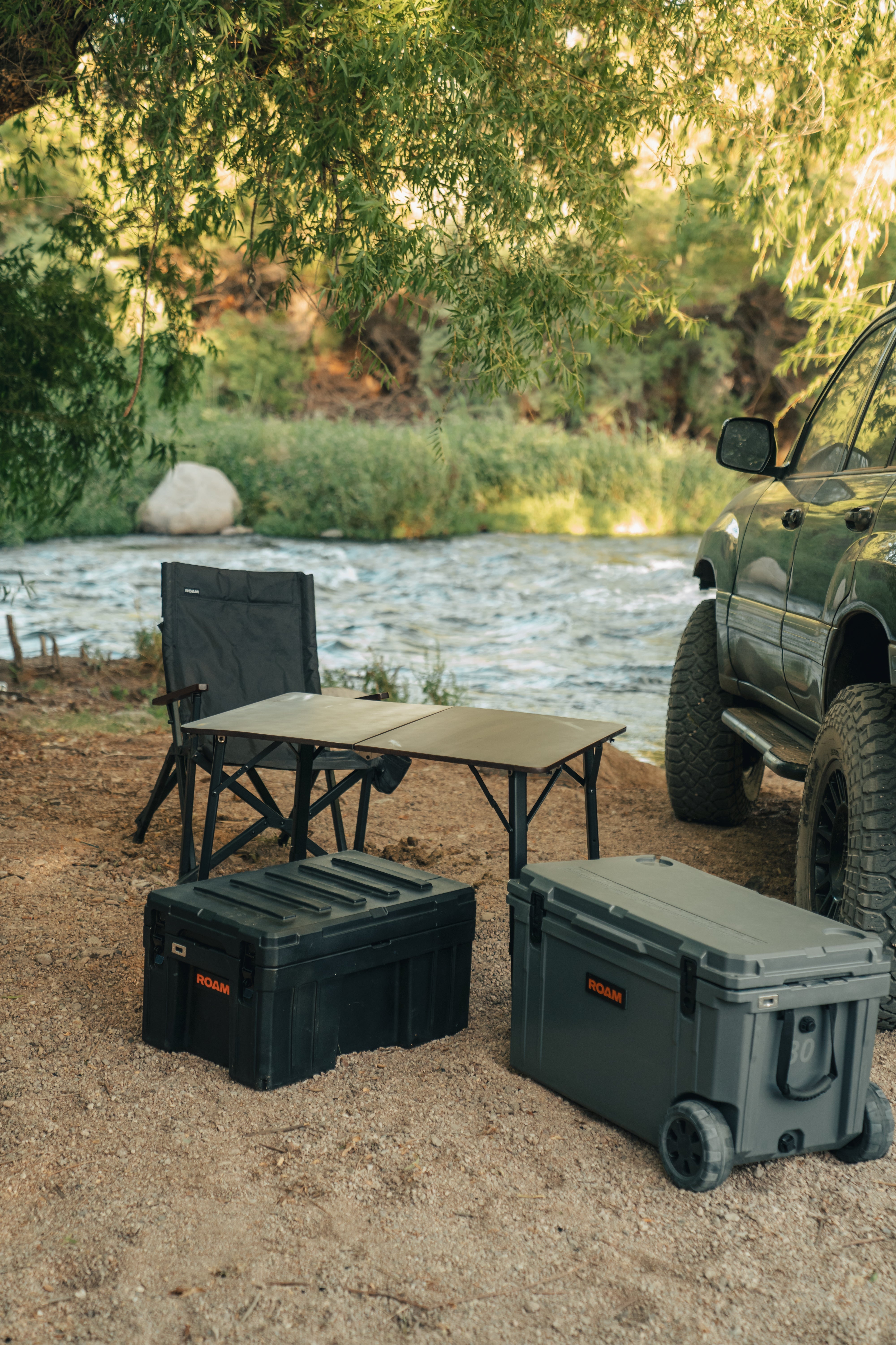 ROAM camp table beside camp chairs