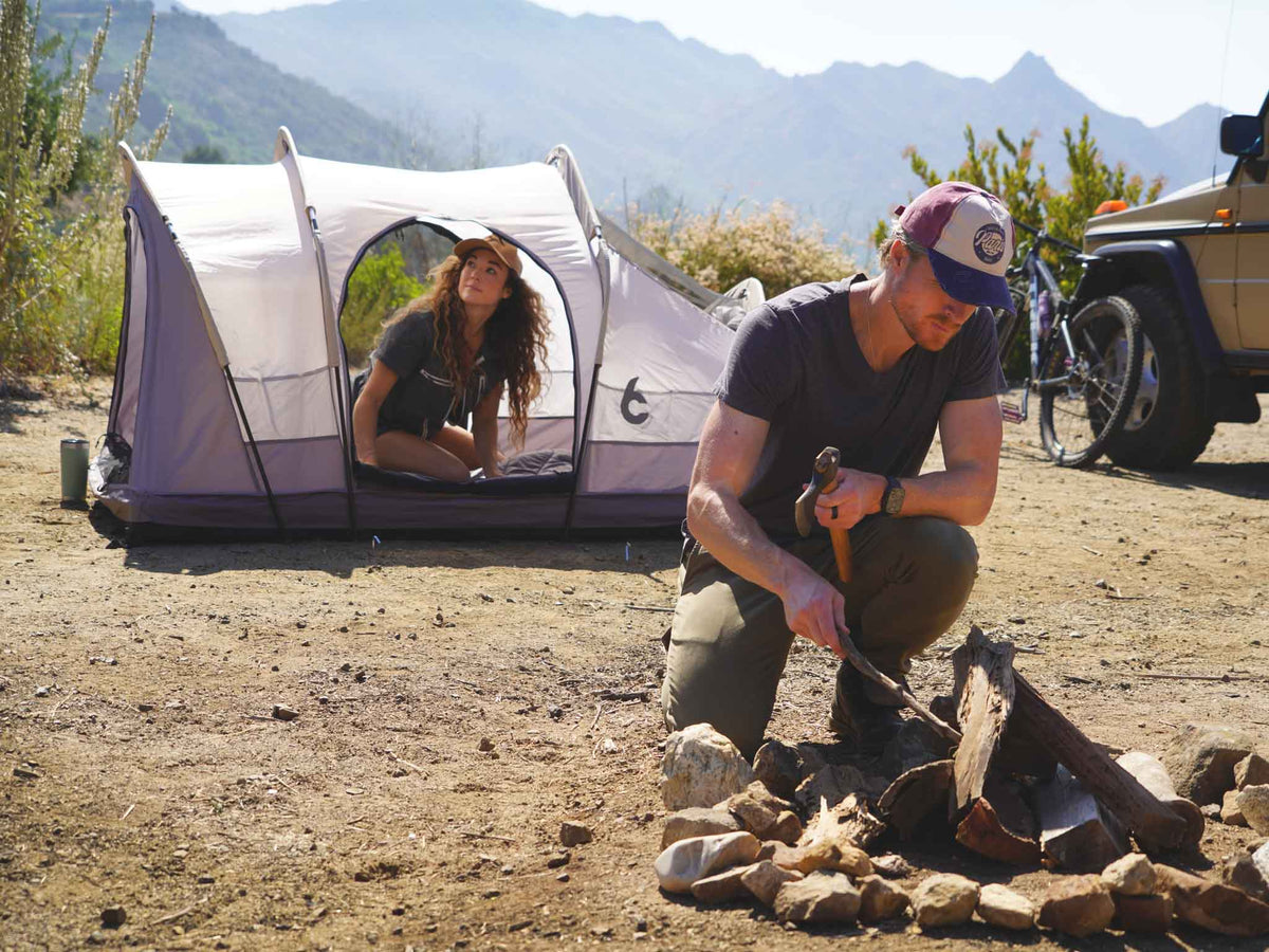 C6 Rev Rack Tent (HellaStorm) – camp scene with campfire and ground tent