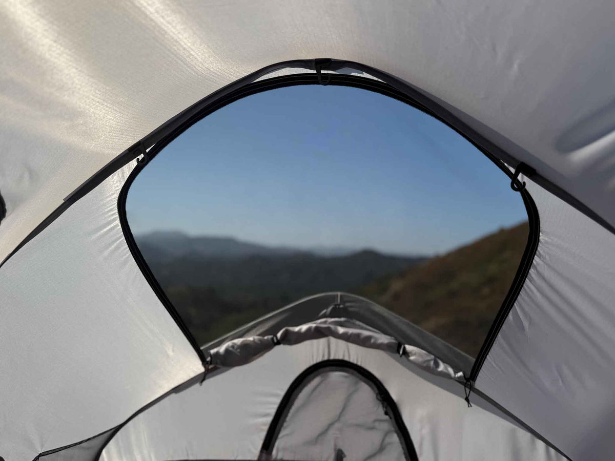 C6 Rev Rack Tent (HellaStorm) – view of hills through the roof window