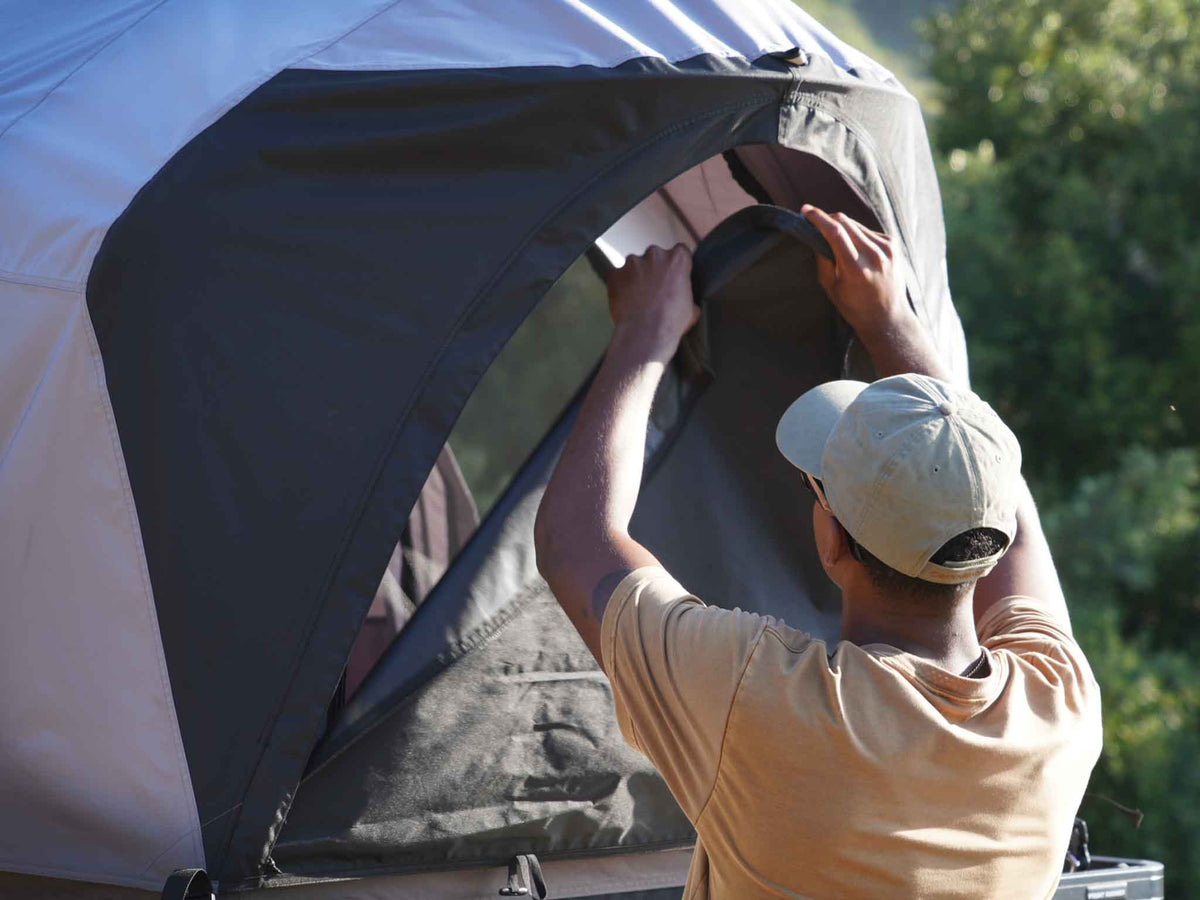 C6 Rev Rack Tent (HellaStorm) – person opening the tent door