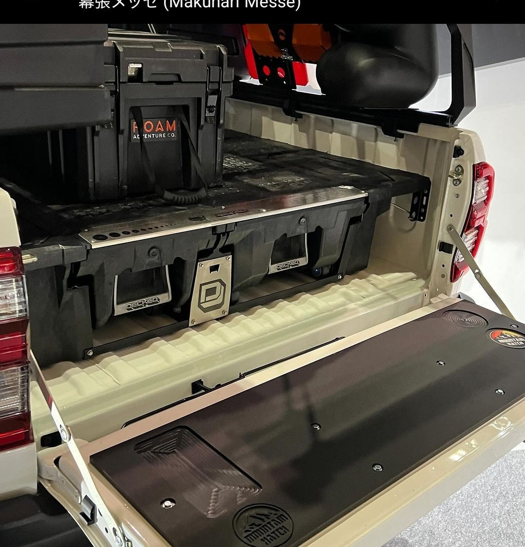Rear view of a 2015-2023 Toyota Hilux with drawers in the bed and the Mountain Hatch panel on the tailgate