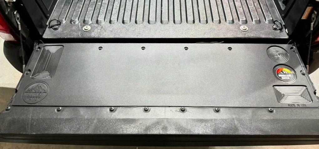 Mountain Hatch recessed-pocket tailgate table installed on a 2005-2023 Toyota Tacoma tailgate, drink holders at right