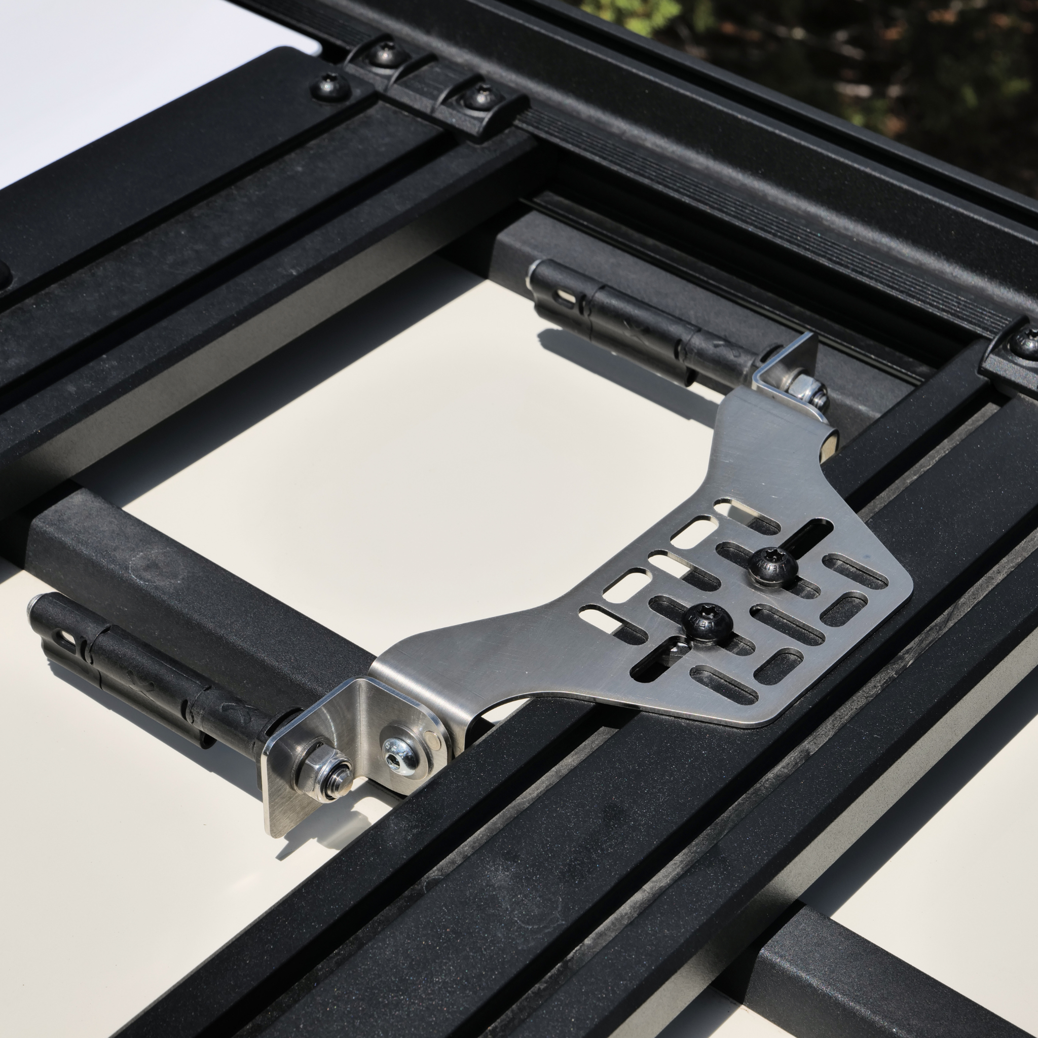 Stealth Folding Mount with Maxtrax Pins attached, Showing pins folded flat on a roof rack