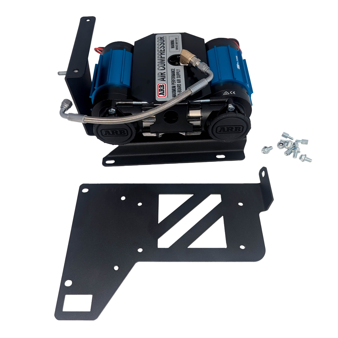 Compressor assembled on the black mount plate with hardware beside it