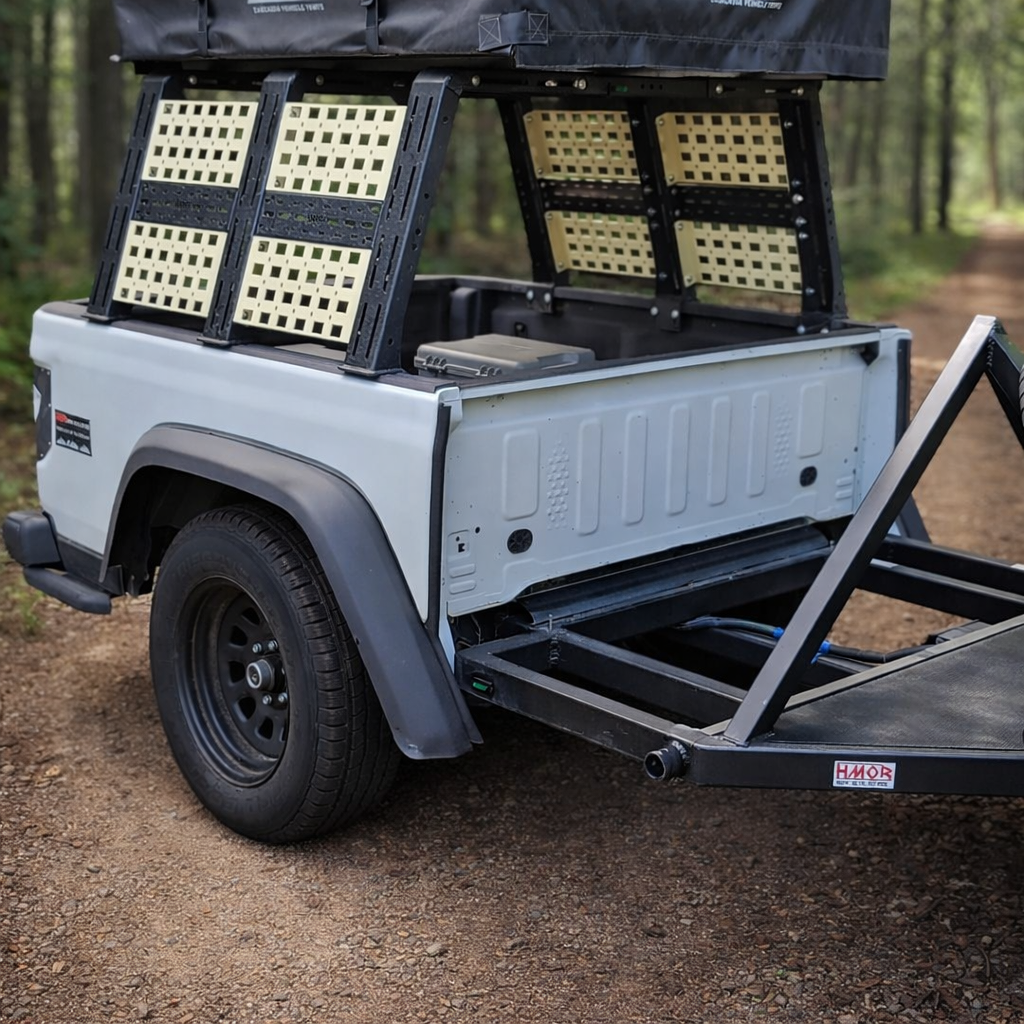 HMOR Universal ROCK-IT rack with tan MOLLE panels on a white truck bed trailer