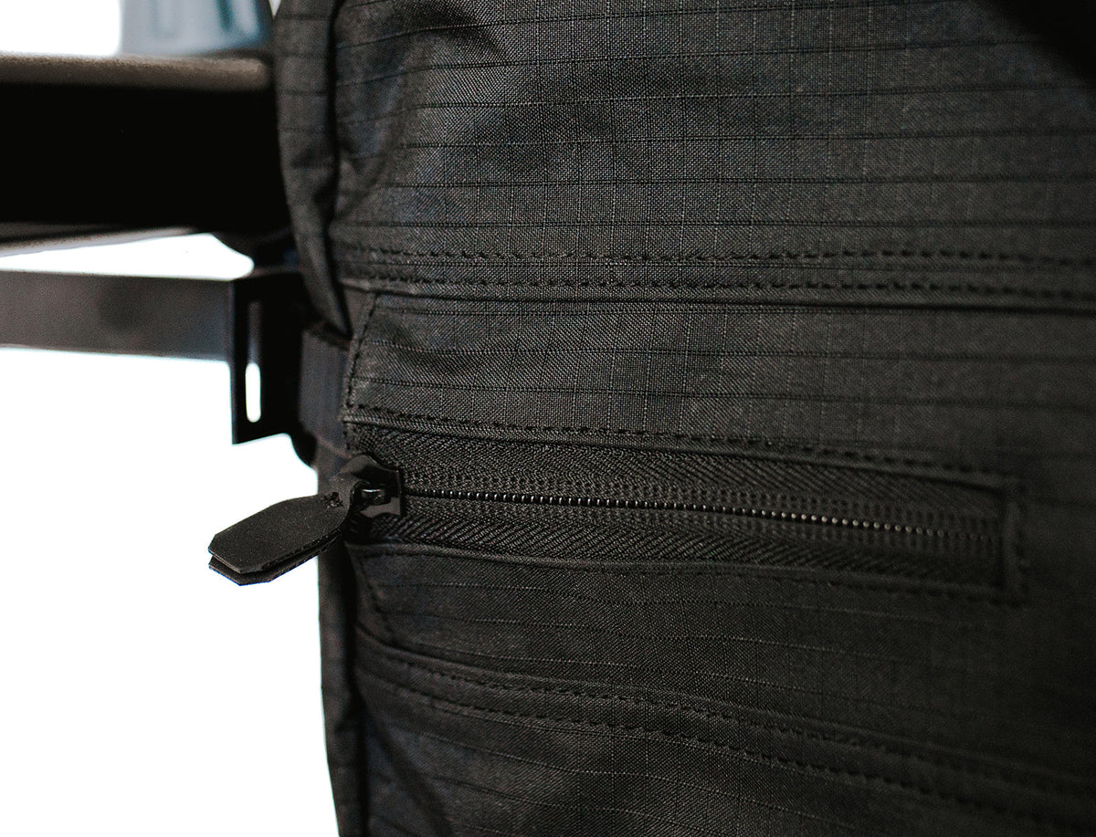 Close-up of the waterproof ripstop nylon and a zippered access panel on the cover