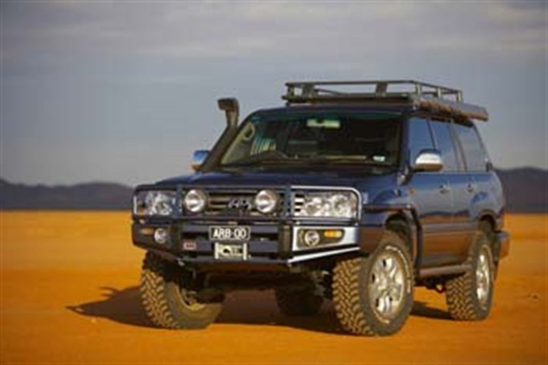 ARB Deluxe winch bumper on an IFS Toyota Land Cruiser 100 Series — front three-quarter view