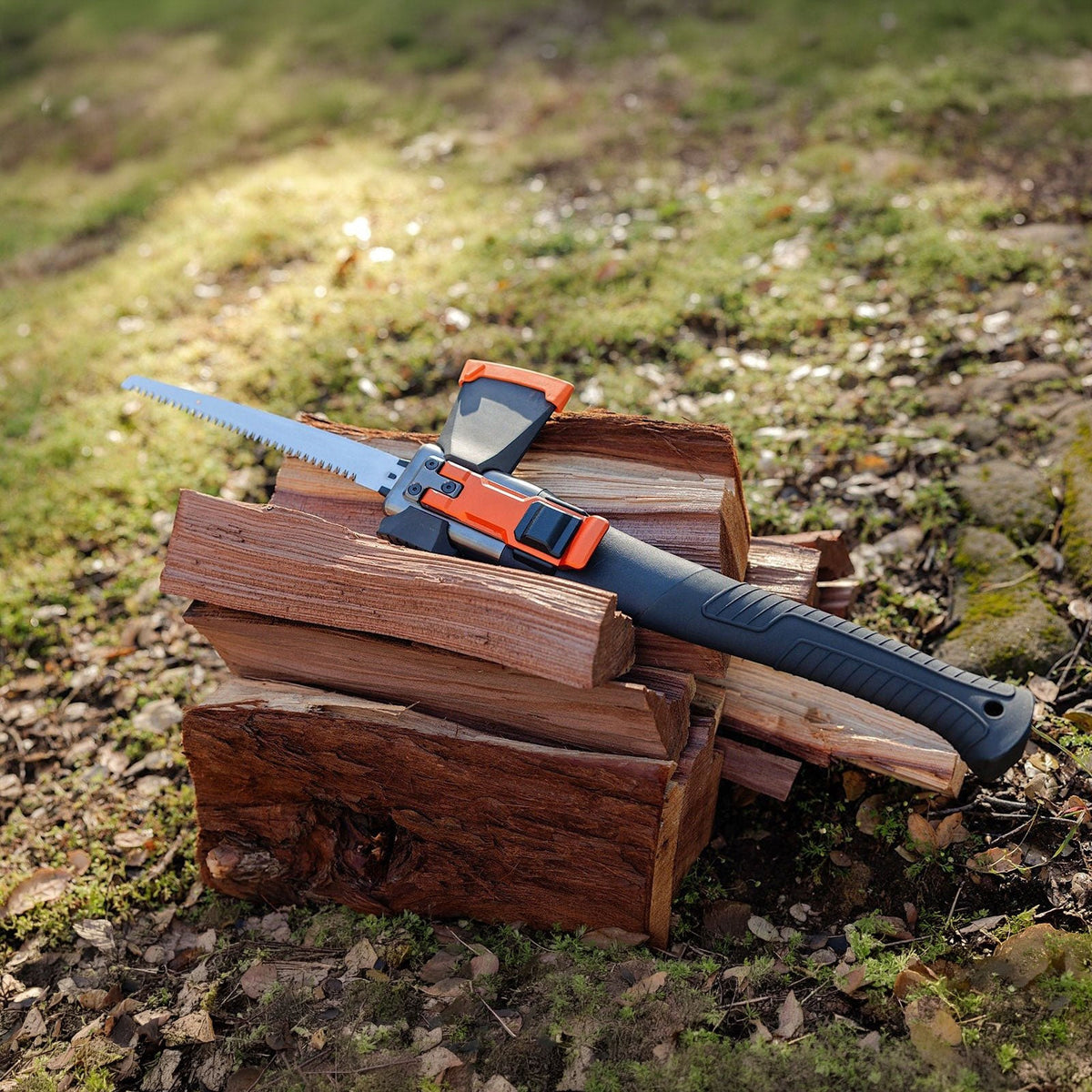 Adventure Mate saw configuration resting on stacked firewood on a grassy patch
