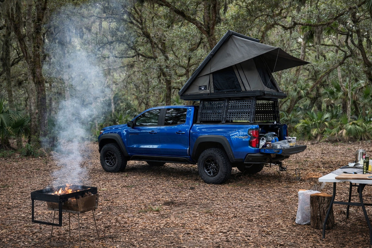 Colorado with ROCK-IT rack and open rooftop tent at a forest campsite