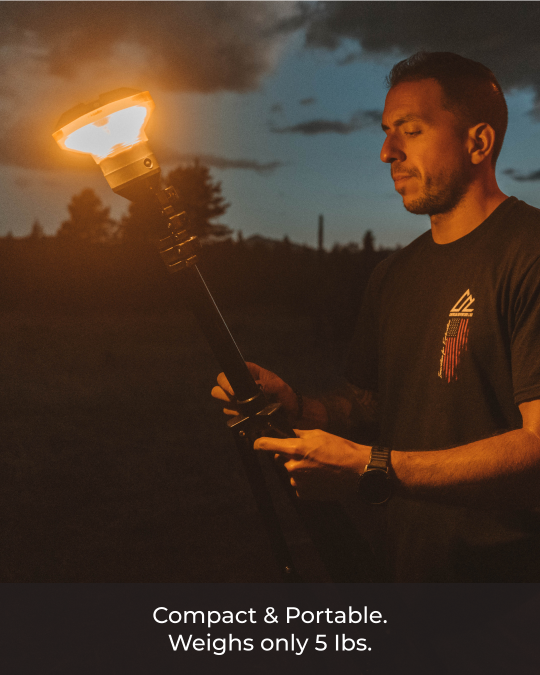 Man holding a large, glowing torch against a dark background