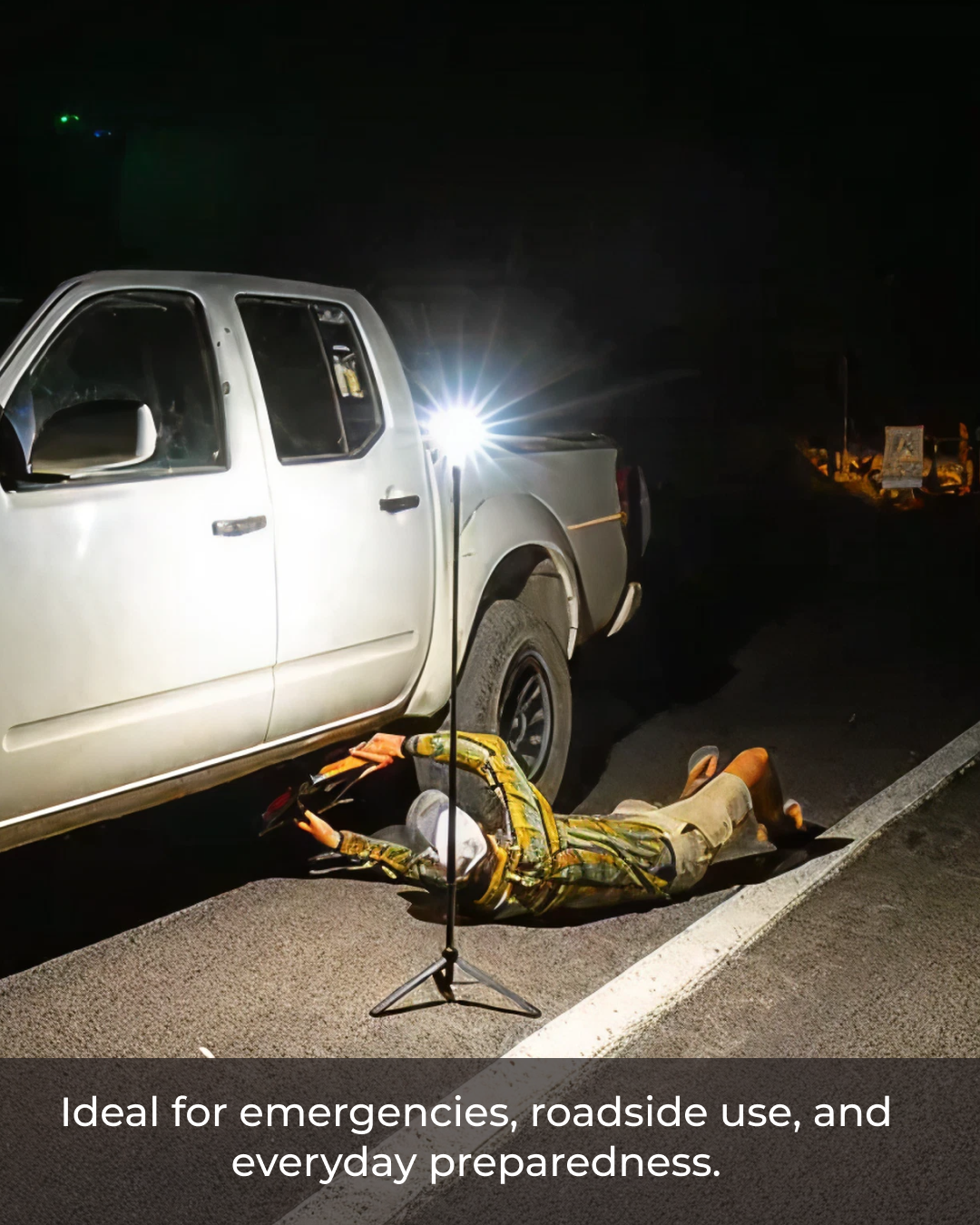 Person lying on the ground next to a car with a Devos Mini, ideal for emergencies.