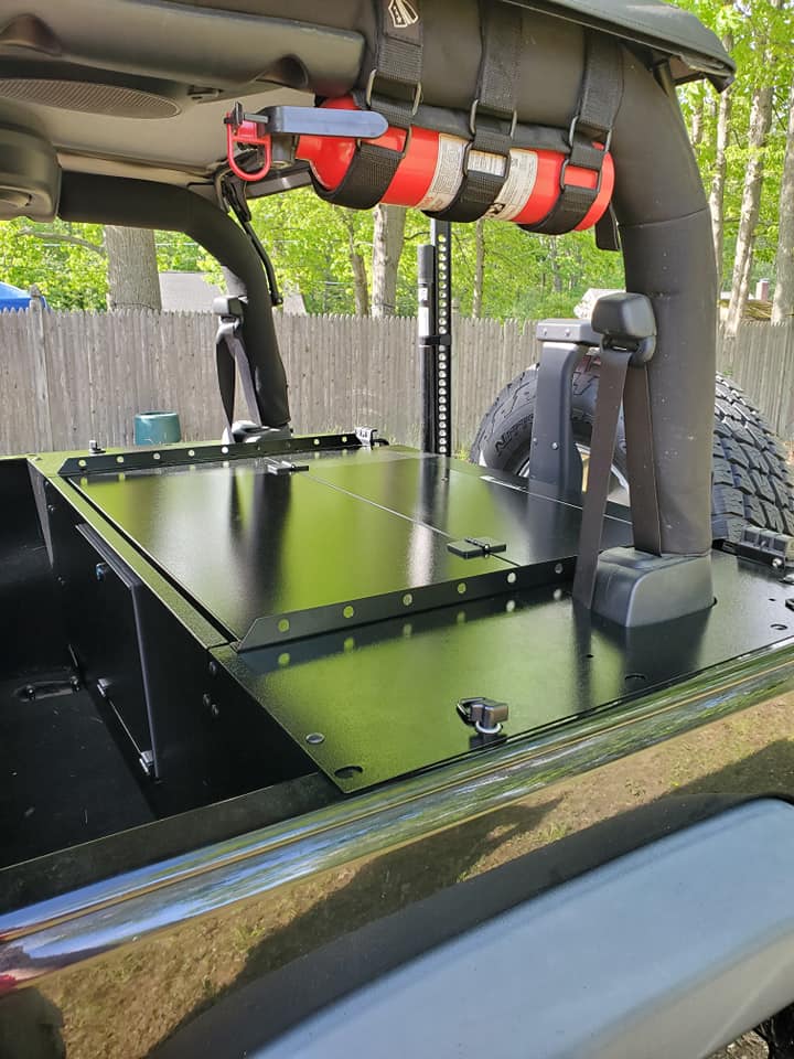 Slipstream folding top closed in a black JK with a fire extinguisher on the roll bar
