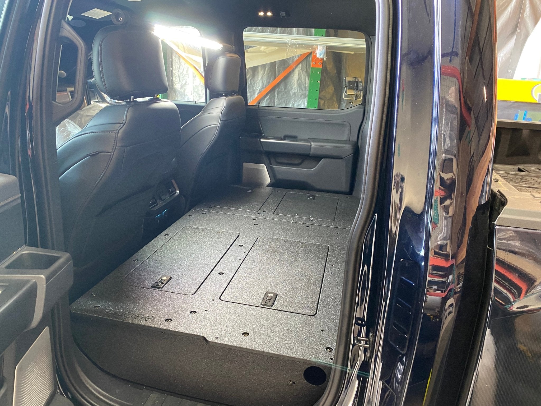 Ford - F150 2021-Present - 14th Gen. SuperCrew - Second Row Seat Delete Plate System with Factory B&O Subwoofer Center Wall with Exterior Port Seat Delete Plate System Goose Gear- Overland Kitted