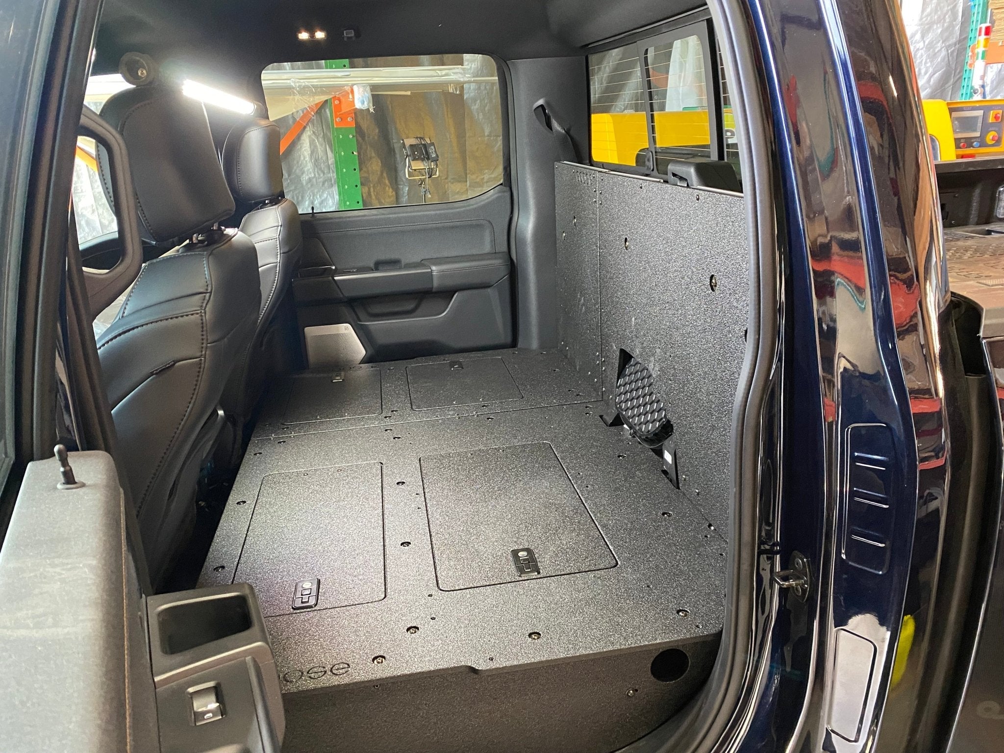 Ford - F150 2021-Present - 14th Gen. SuperCrew - Second Row Seat Delete Plate System with Factory B&O Subwoofer Center Wall with Exterior Port Seat Delete Plate System Goose Gear- Overland Kitted