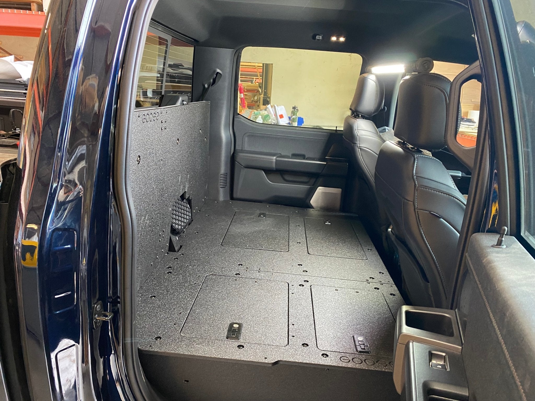 Ford - F150 2021-Present - 14th Gen. SuperCrew - Second Row Seat Delete Plate System with Factory B&O Subwoofer Center Wall with Exterior Port Seat Delete Plate System Goose Gear- Overland Kitted