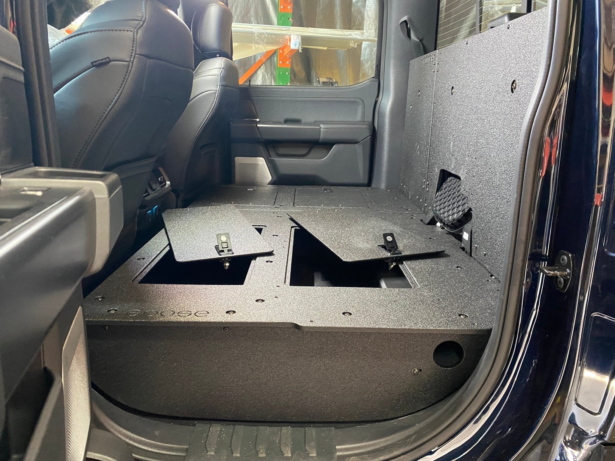 Ford - F150 2021-Present - 14th Gen. SuperCrew - Second Row Seat Delete Plate System with Factory B&O Subwoofer Center Wall with Exterior Port Seat Delete Plate System Goose Gear- Overland Kitted