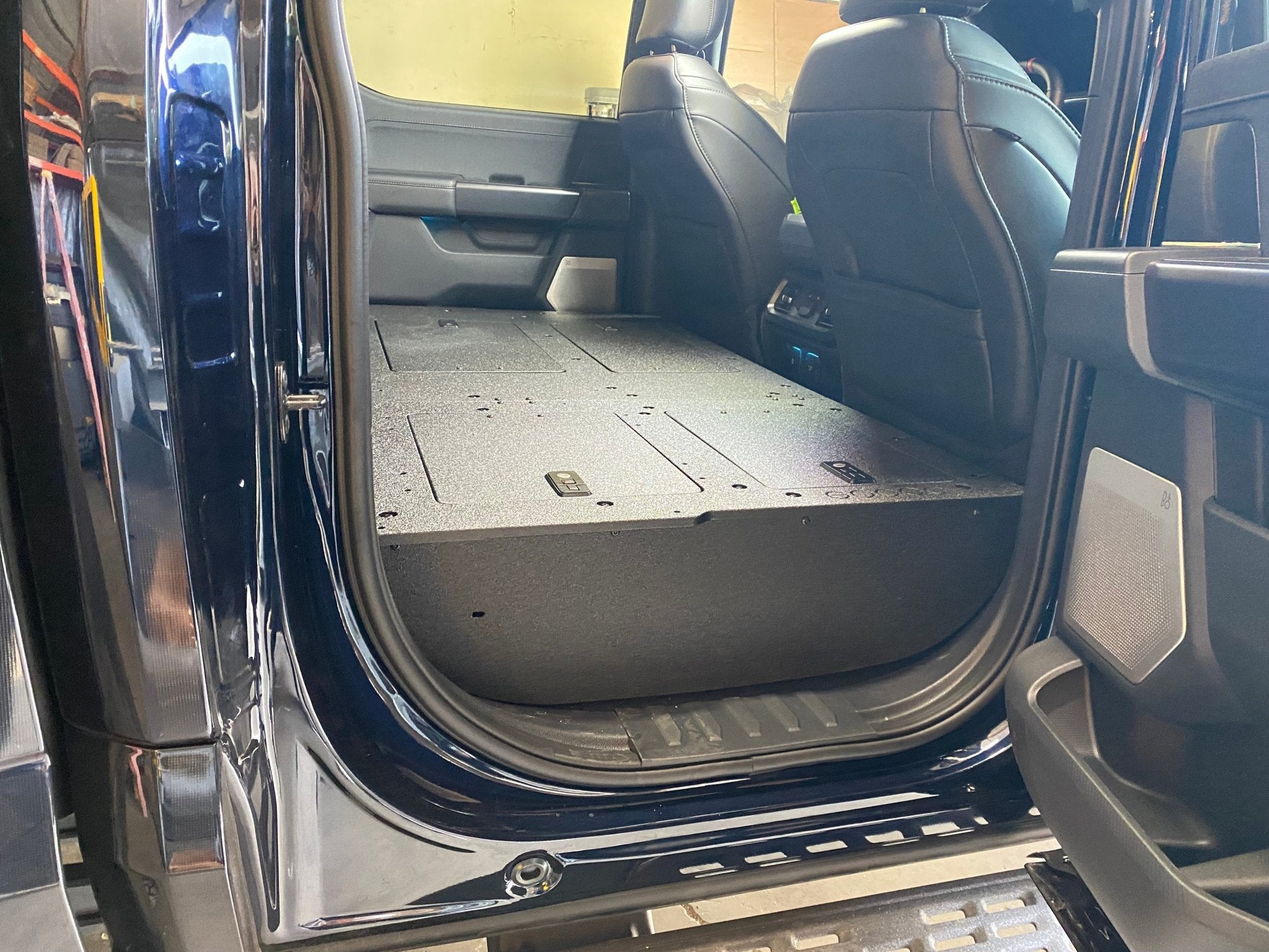 Ford - F150 2021-Present - 14th Gen. SuperCrew - Second Row Seat Delete Plate System with Factory B&O Subwoofer Center Wall with Exterior Port Seat Delete Plate System Goose Gear- Overland Kitted