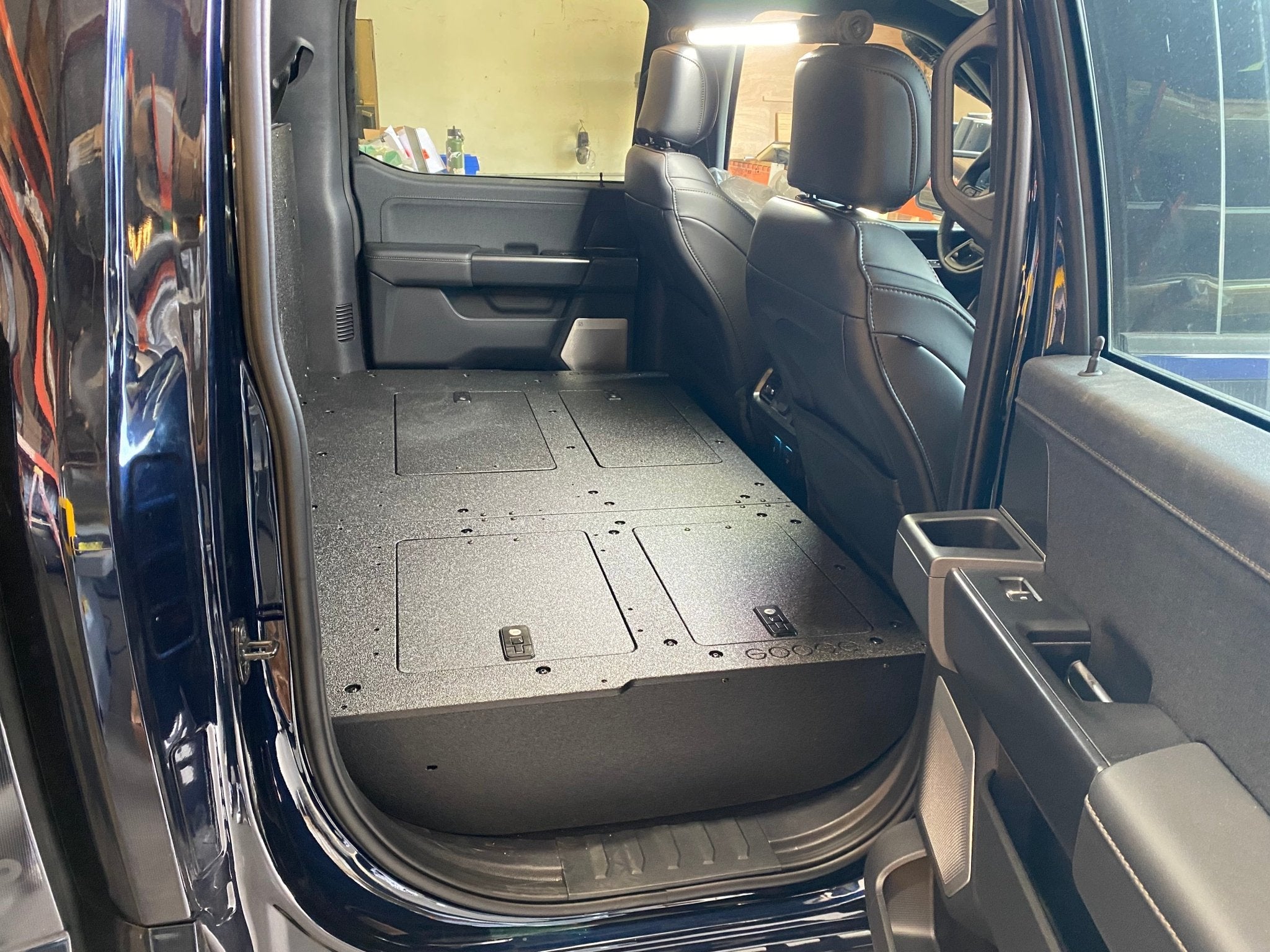 Ford - F150 2021-Present - 14th Gen. SuperCrew - Second Row Seat Delete Plate System with Factory B&O Subwoofer Center Wall with Exterior Port Seat Delete Plate System Goose Gear- Overland Kitted