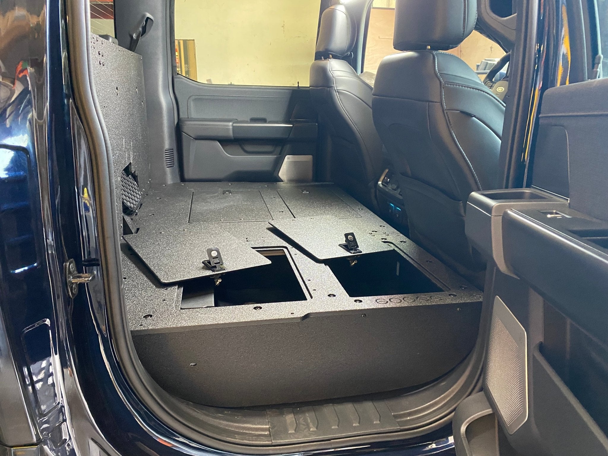 Ford - F150 2021-Present - 14th Gen. SuperCrew - Second Row Seat Delete Plate System with Factory B&O Subwoofer Center Wall with Exterior Port Seat Delete Plate System Goose Gear- Overland Kitted