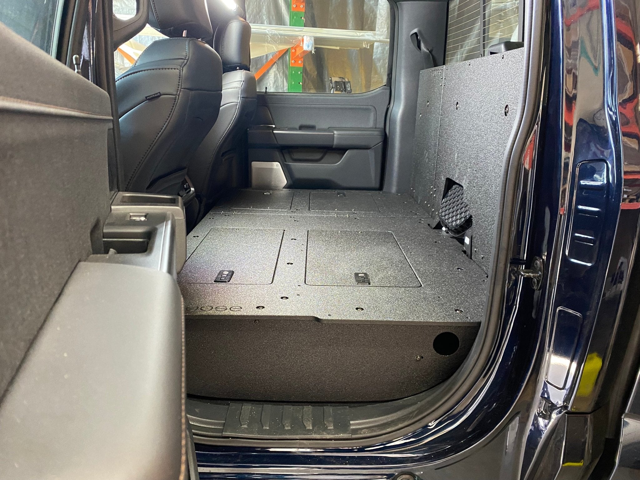 Ford - F150 2021-Present - 14th Gen. SuperCrew - Second Row Seat Delete Plate System with Factory B&O Subwoofer Center Wall with Exterior Port Seat Delete Plate System Goose Gear- Overland Kitted