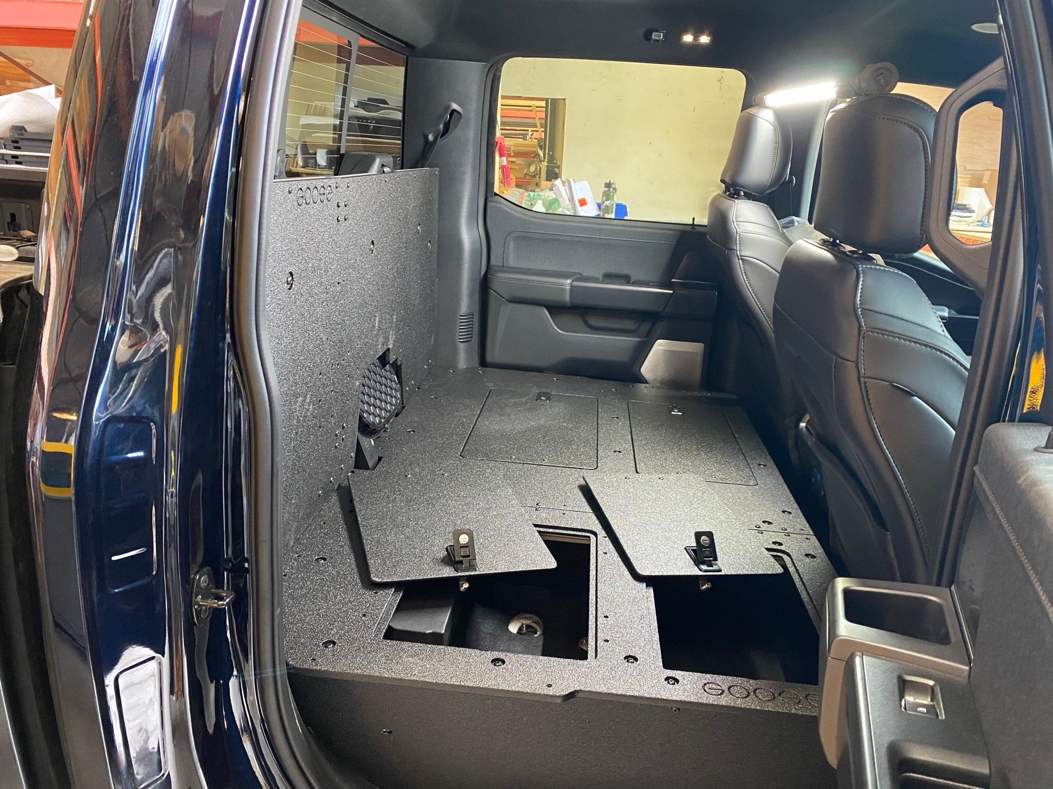 Ford - F150 2021-Present - 14th Gen. SuperCrew - Second Row Seat Delete Plate System with Factory B&O Subwoofer Center Wall with Exterior Port Seat Delete Plate System Goose Gear- Overland Kitted