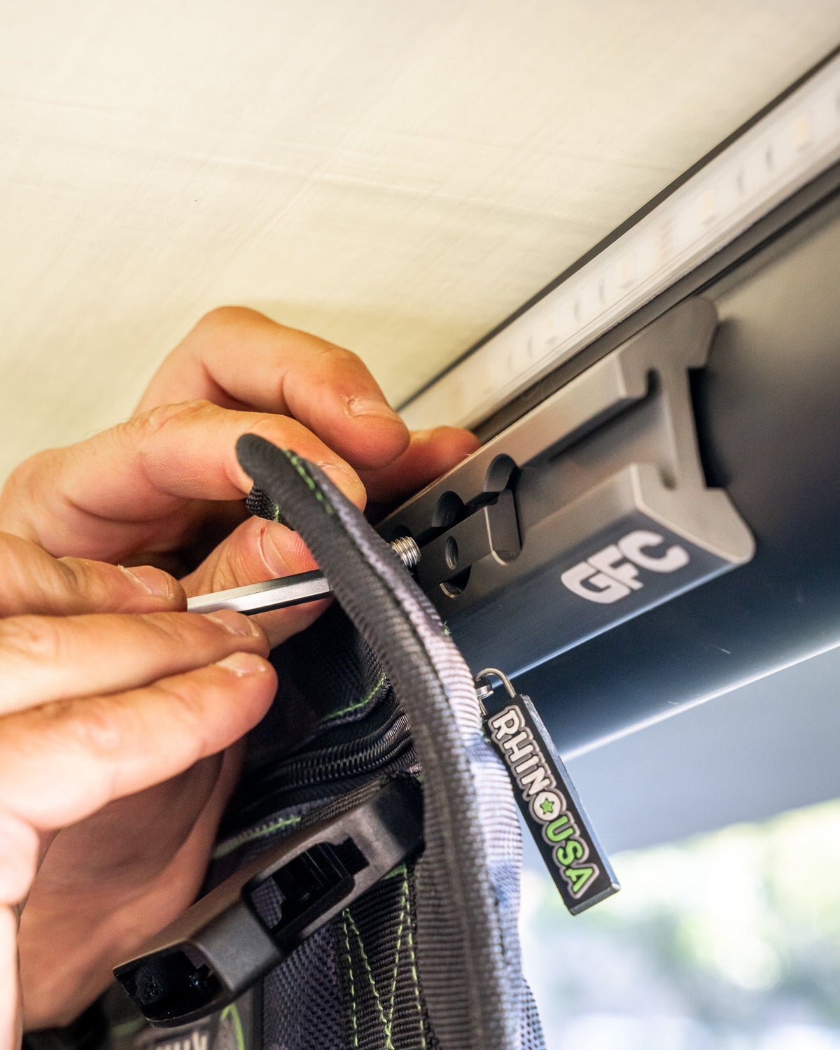 Fitting a tool roll strap to the track with an L-track nut and bolt