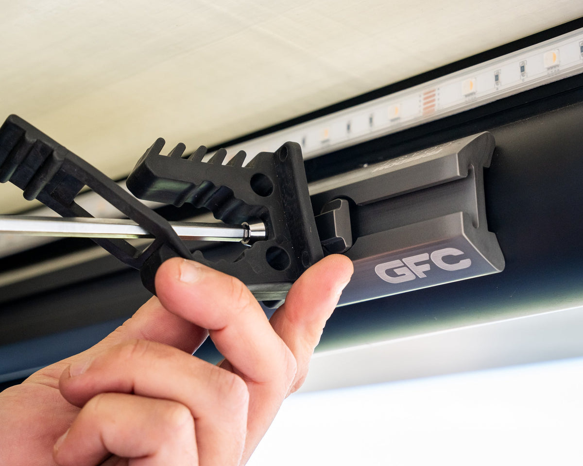 Positioning a bracket along camper L-track before tightening