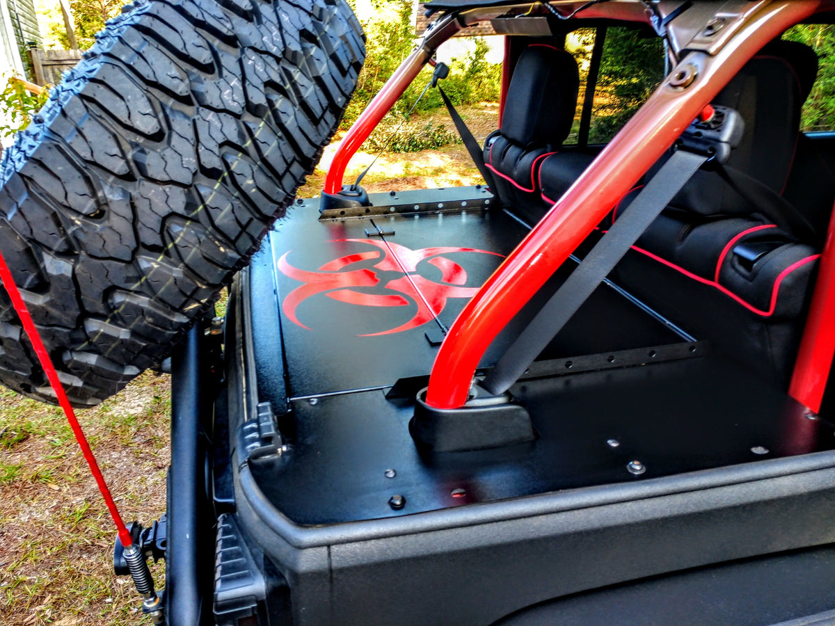 Biohazard-graphic Slipstream top beside the JKU roll bar and spare tire