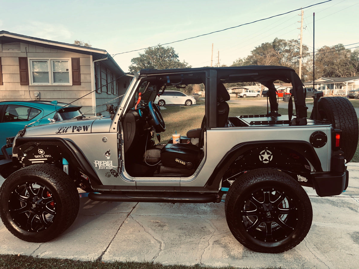 Silver Jeep JK 2-door with lifted suspension and black wheels