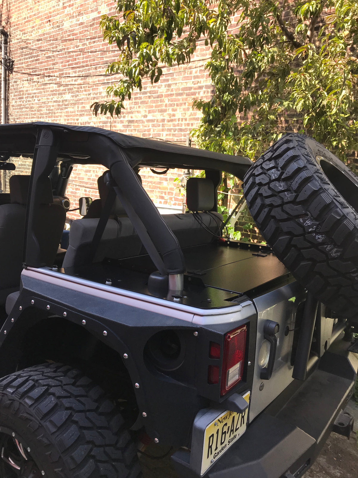 Black Jeep JKU from the rear quarter with the Slipstream and wing skins fitted
