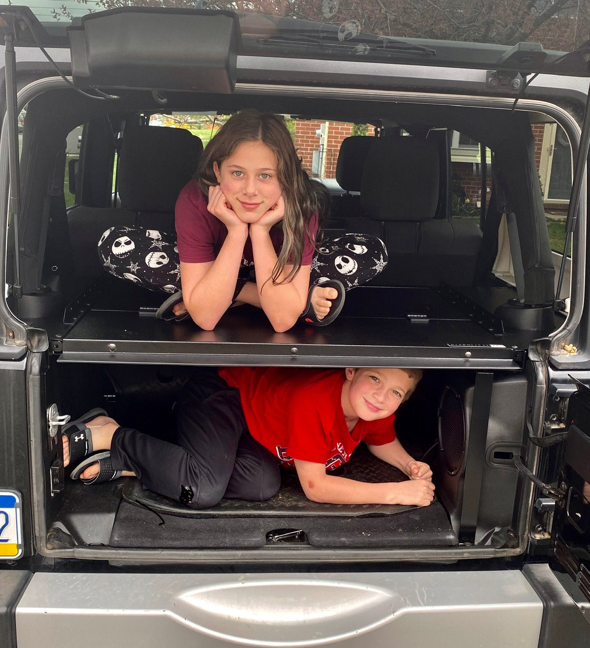 Two kids showing the Slipstream's strength, one on the top and one inside the compartment